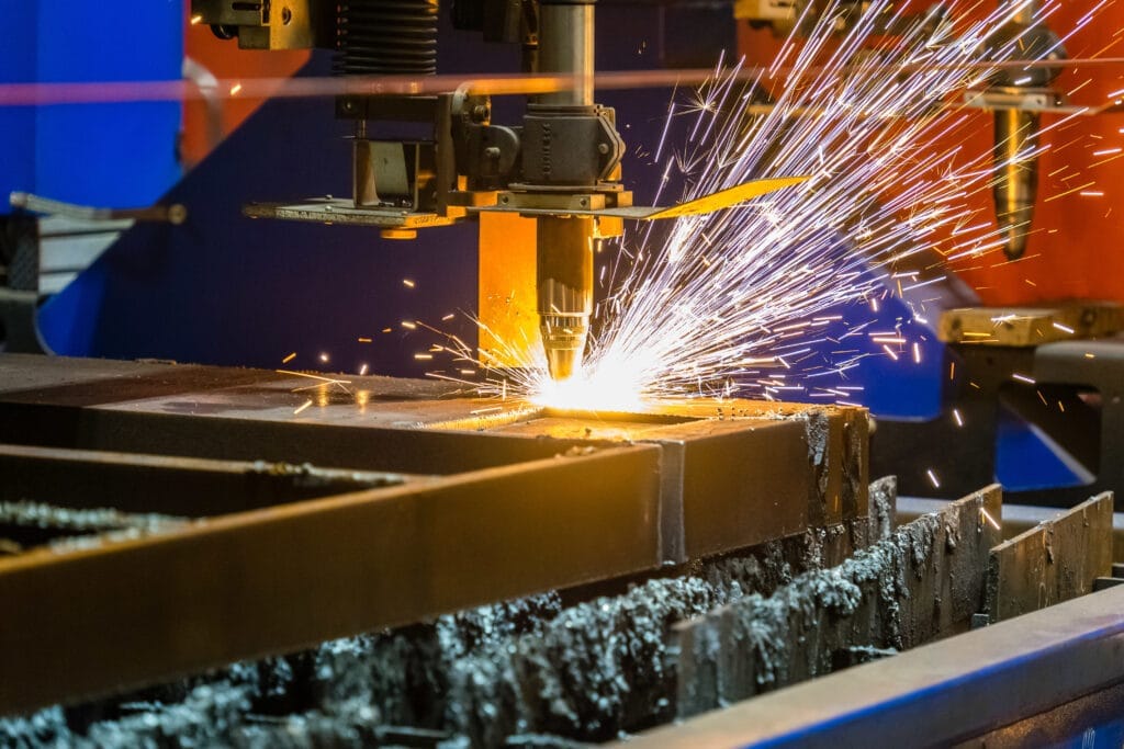 closeup shot sparks flying from industrial steel cutter CNC Operatörlük Belgesi Nasıl Alınır