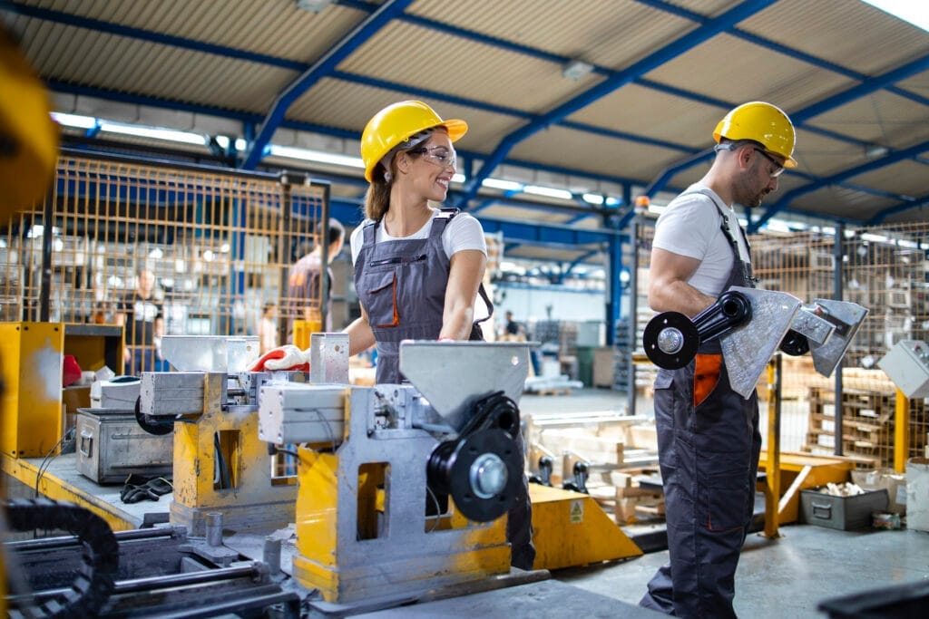 industrial employees working together factory production line CNC Operatörlük Belgesi Nasıl Alınır