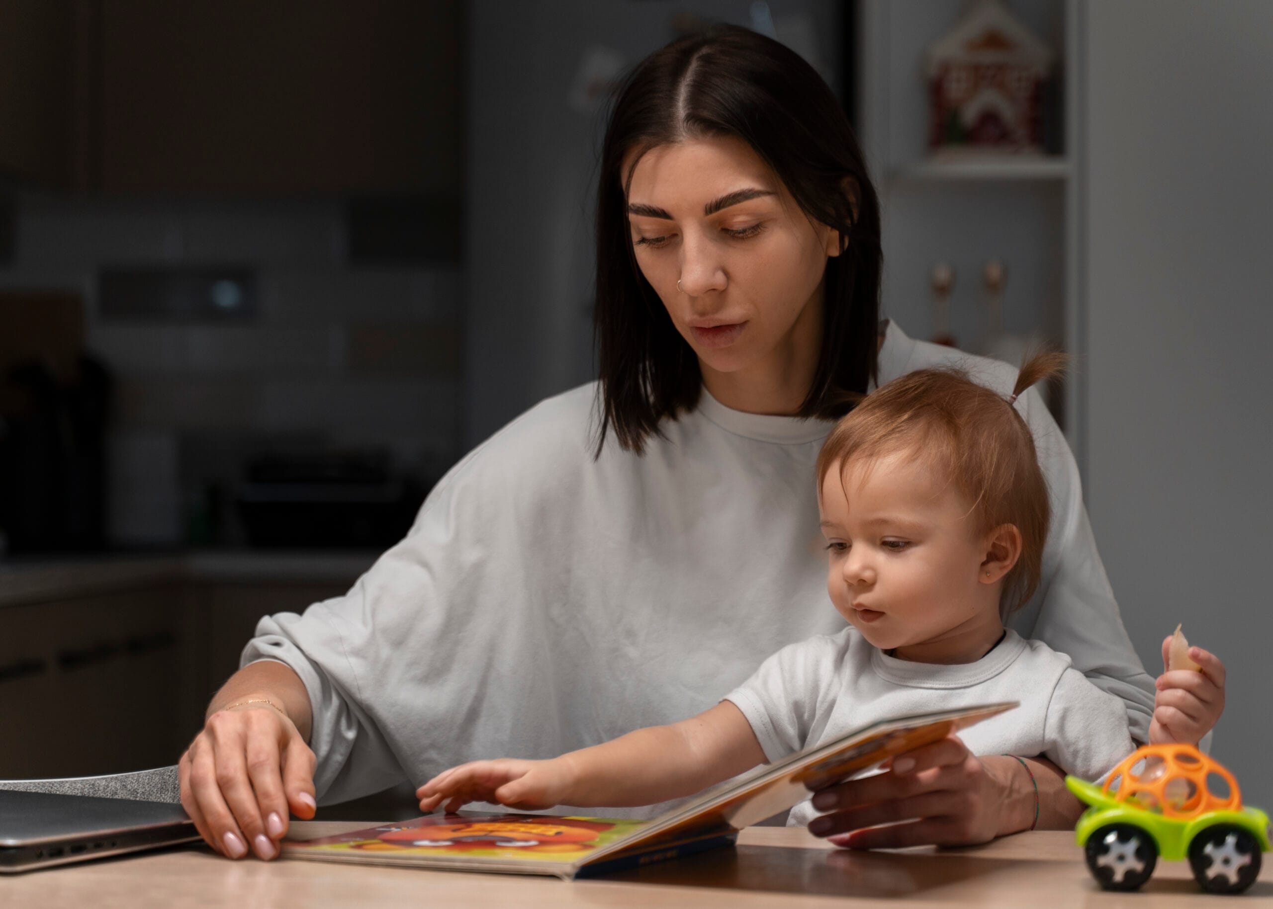 medium shot mother baby with book scaled Çocuk Gelişimi Sertifikası Nasıl Alınır