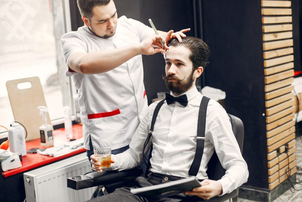 stylish man sitting barbershop Berberlik Ustalık Belgesi Nasıl Alınır?