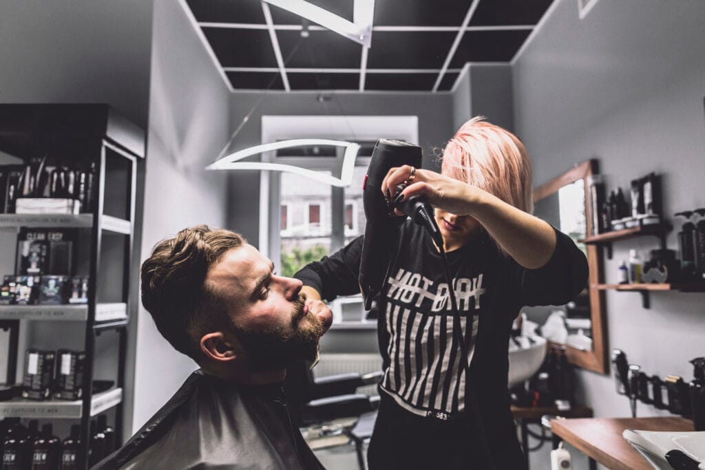 woman using dryer beard man Berberlik Ustalık Belgesi Nasıl Alınır?