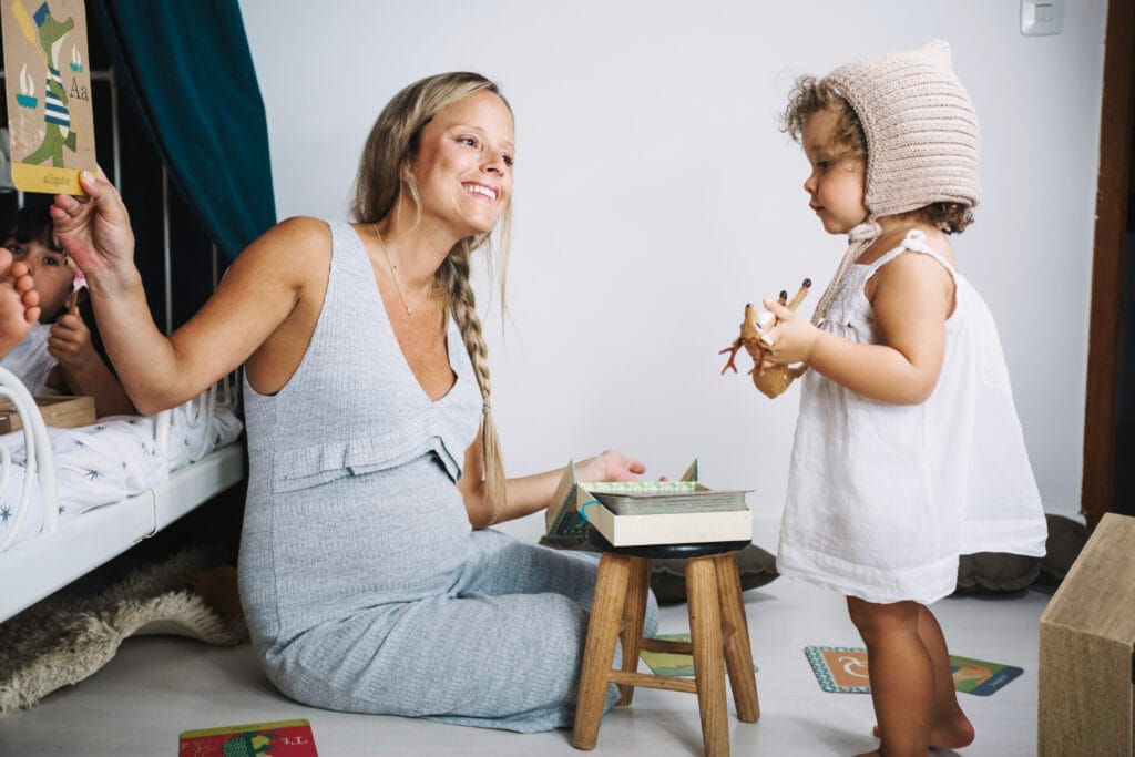 mother playing with daughter floor Okul Öncesi Çocuk Gelişimi ve Eğitimi