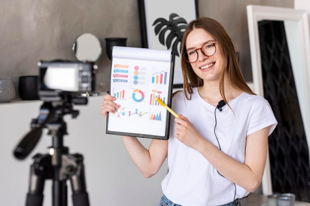 young blogger recording with professional camera holding clipboard with graphics halkla ilişkiler uzaktan eğitim sertifika programı