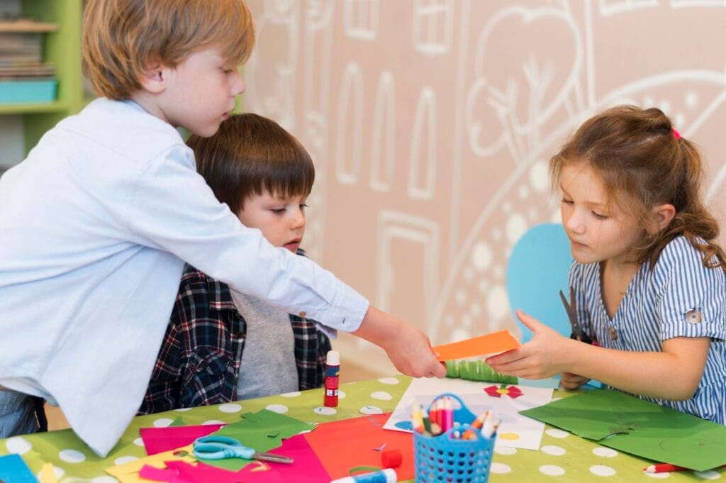 medium shot kids working together Okul Öncesi Sertifikası Nasıl Alınır?