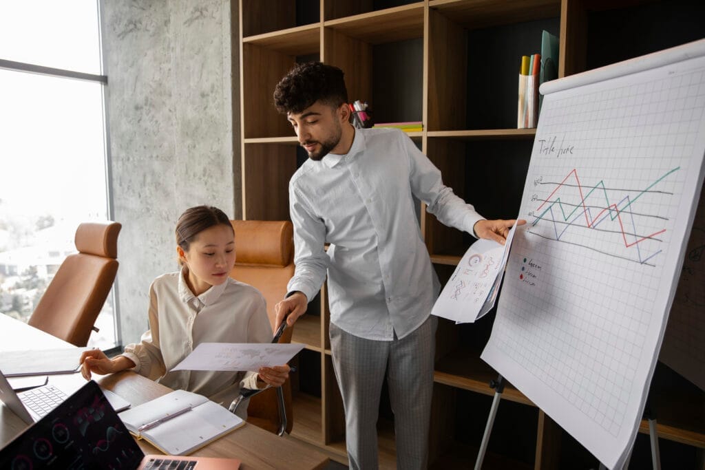 office workers using finance graphs Oryantasyon Belgesi
