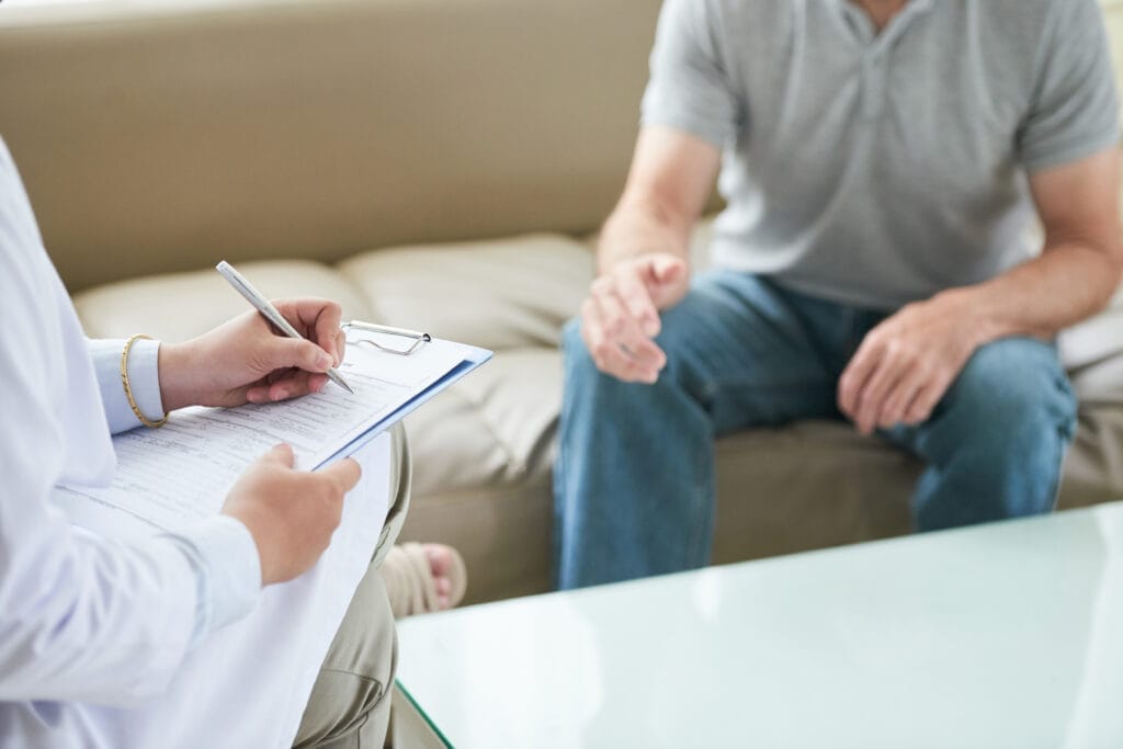 unrecognizable female doctor talking patient writing house call Duygu Odaklı Terapi Eğitimi Nereden Alınır?
