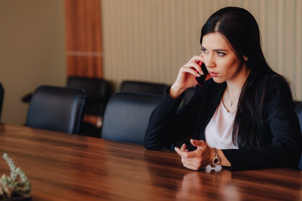 young attractive emotional girl business style clothes sitting desk with phone office audience Hukuk ve Adli Sekreterlik Sertifikası